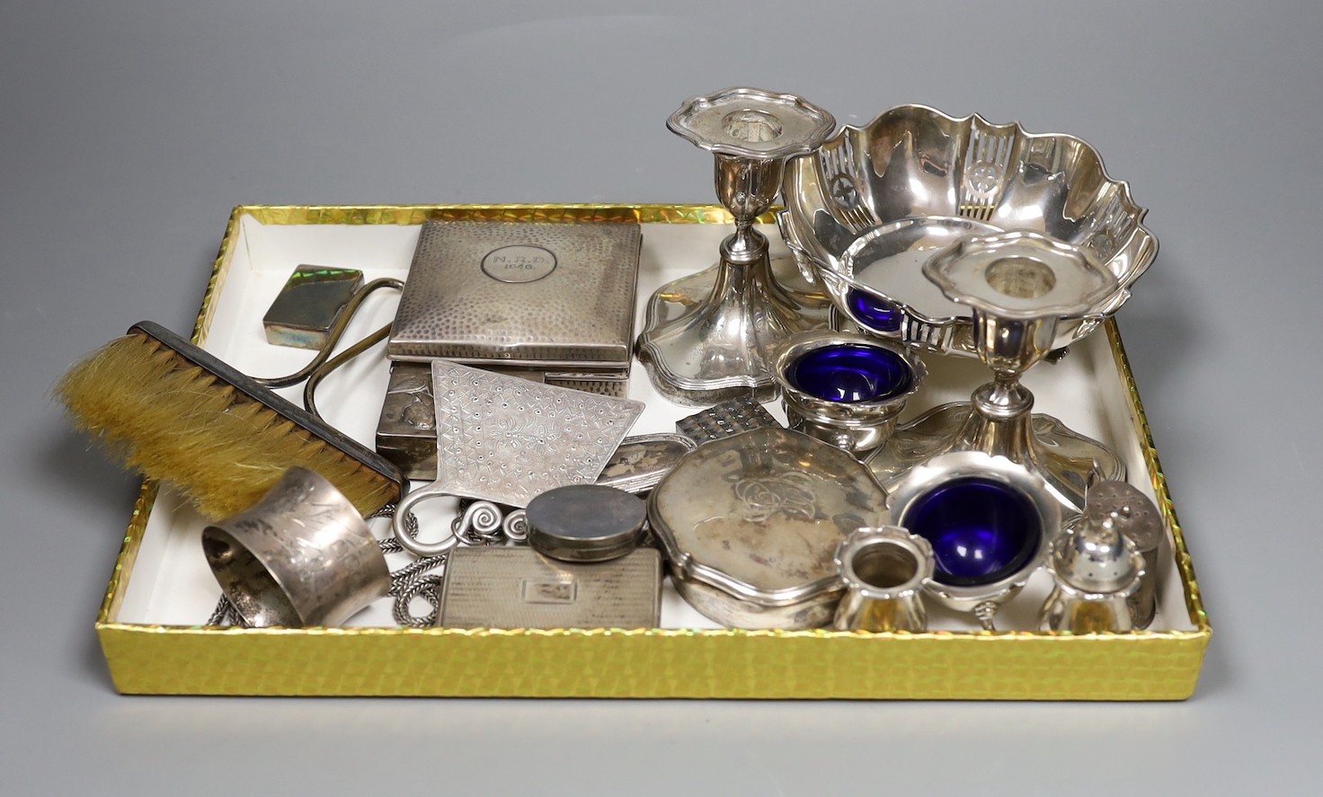 Assorted silver including a pierced bowl, pair of dwarf candlesticks, four condiments(a.f.), cigarette box, lid, 19th century snuff box and vinaigrette, match sleeve oval pill box, oval pepperette with handle and modern